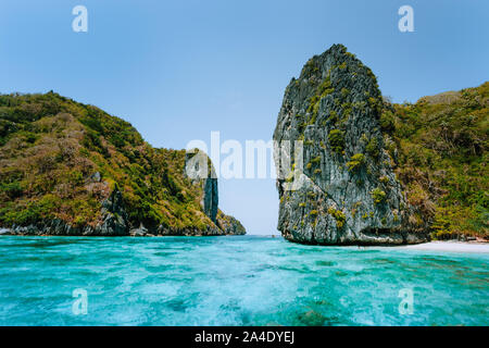 El Nido, Palawan, Philippines. Aerial view of towering cliffs in front of tropical Island with white sandy beach Stock Photo