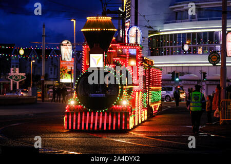 Passengers getting ready to board an illuminated tram for a tour through the illuminations. Stock Photo
