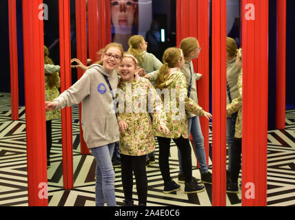 Two girls in a mirror maze. Stock Photo