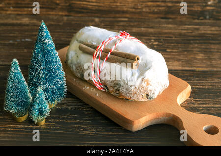 Traditional German cake Stollen, fruit bread with dried fruit and nuts, covered with powdered icing sugar, usually eaten during  Christmas season and Stock Photo