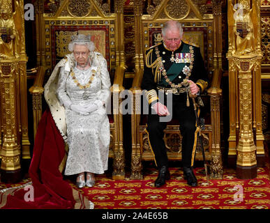 Queen Elizabeth II with the Prince of Wales and the Duchess of Cornwall as she delivers the Queen's Speech during the State Opening of Parliament in the House of Lords at the Palace of Westminster in London. Stock Photo