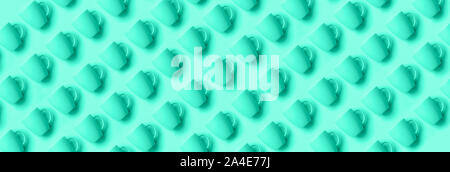 Pattern from mint cups over mint color background. Birthday party celebration, baby shower concept. Trendy green and turquoise color. Banner. Minimali Stock Photo