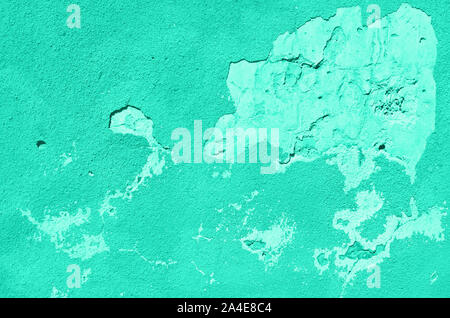 Old cracked turquoise wall. Painted texture background in mint color. Trendy green and turquoise color. Banner. Stock Photo