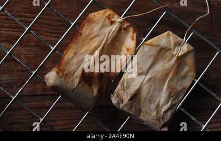 The old tea bag on the wooden floor Stock Photo