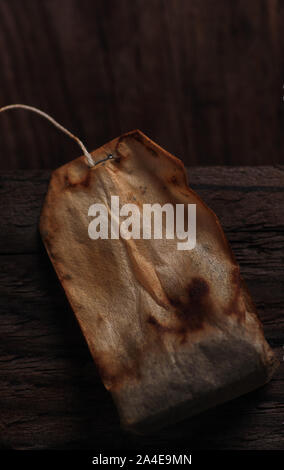 The old tea bag on the wooden floor Stock Photo