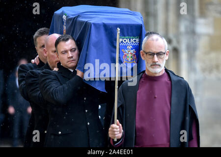 Clergy lead the pallbearers as they carry the coffin of PC Andrew Harper, the Thames Valley Police officer who died from multiple injuries after being dragged under a van while responding to reports of a burglary, as the cortege leaves the quadrangle at Christ Church Cathedral in St Aldate's, Oxford. Stock Photo