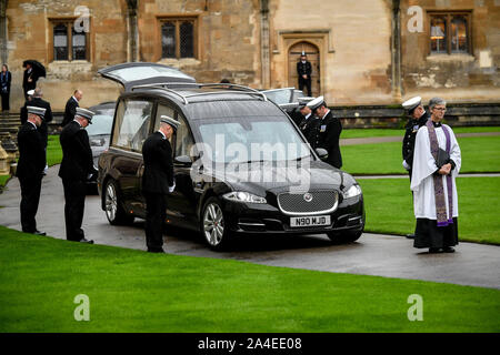 The guard of honour bow beside the hearse containing the coffin of PC Andrew Harper, the Thames Valley Police officer who died from multiple injuries after being dragged under a van while responding to reports of a burglary, as the cortege leaves the quadrangle at Christ Church Cathedral in St Aldate's, Oxford. Stock Photo