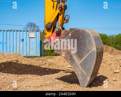 Excavator shovel in the ground Stock Photo