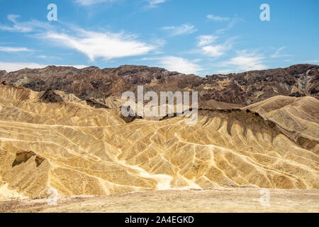 Eroding volcanic ash and silt hills, badlands, at Zabriskie Point, Death Valley National Park, California, USA Stock Photo