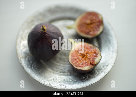 One whole fig and the second cut in half Stock Photo