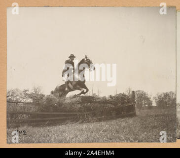 Theodore Roosevelt, on horseback, jumping fence Stock Photo