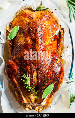 Christmas baked duck with herbs and spices in the oven dish. Stock Photo