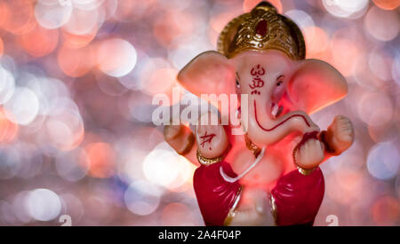 Ganesha statue with beutiful lights in the background for Ganpati pooja  concept Stock Photo - Alamy