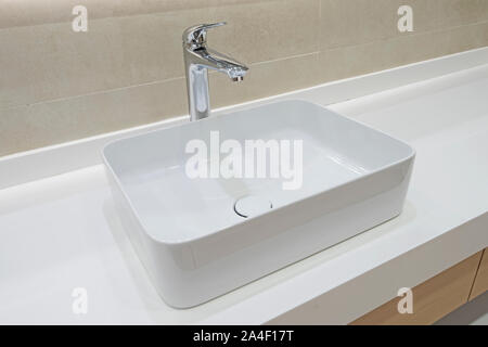 Closeup detail showing interior design of a luxury show home bathroom sink on counter top Stock Photo