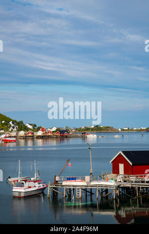 A view over a dock and fishing boat to Reine on Reine Fjord, Moskenesoya, the Lofoten Islands, Norway, Europe Stock Photo