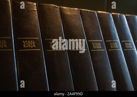 Porvoo, Finland - 2 October 2019: Closeup of a row of green hymn books on finnish language in Porvoo Cathedral. Stock Photo