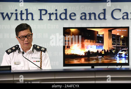 Hong Kong. 14th Oct, 2019. Tang Ping-keung, deputy commissioner of police, shows an evidence image of violent acts by rioters to throw petrol bombs at Mong Kok police station during a press conference in south China's Hong Kong, Oct. 14, 2019. With a terrorism-style explosion and a slash-neck attack, masked rioters have become more aggressive in attacking police officers in escalating violent incidents in Hong Kong. Credit: Xinhua/Alamy Live News Stock Photo