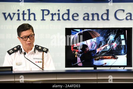 Hong Kong. 14th Oct, 2019. Tang Ping-keung, deputy commissioner of police, shows an evidence image of violent acts by rioters during a press conference in south China's Hong Kong, Oct. 14, 2019. With a terrorism-style explosion and a slash-neck attack, masked rioters have become more aggressive in attacking police officers in escalating violent incidents in Hong Kong.   An improvised explosive device (IED), known as the homemade bomb, was used for the first time in Hong Kong against police officers on Sunday, according to the press conference. Credit: Xinhua/Alamy Live News Stock Photo