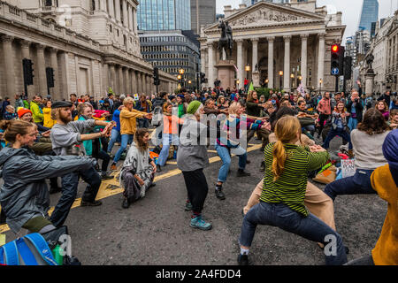 London, UK. 14th Oct, 2019. Protestors move into the financial centre by blocking the junction at Bank' - The sixth day of the Extinction Rebellion October action which has blocked roads in central London. They are again highlighting the climate emergency, with time running out to save the planet from a climate disaster. This is part of the ongoing ER and other protests to demand action by the UK Government on the 'climate crisis'. The action is part of an international co-ordinated protest. Credit: Guy Bell/Alamy Live News Stock Photo