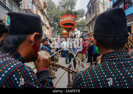 Kathmandu, Nepal. 14th Oct, 2018. Devotees play the traditional instruments during a chariot procession of lord Satya Narayan.Every year people across the valley come to the Hadigaun to take part in this unique festival, carrying the chariots to appease the Hindu Lord Narayan. Credit: Sunil Pradhan/SOPA Images/ZUMA Wire/Alamy Live News Stock Photo