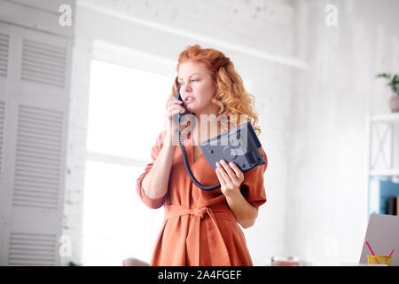 Woman having business call while working from home Stock Photo