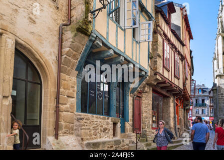 Tourists walking in street with 16th century timber framed / half timbered houses in the old town of the city Vannes, Morbihan, Brittany, France Stock Photo