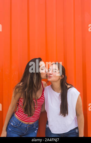 Woman kissing friend’s cheek at birthday party Stock Photo - Alamy