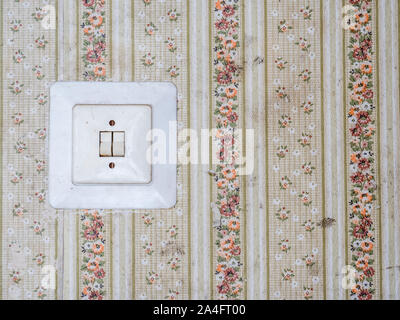 Vintage light switch with retro wallpaper Stock Photo