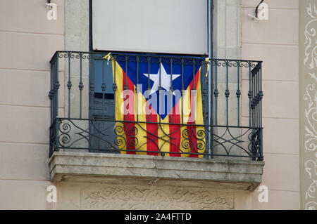 La Estelada Blava flag hanging on a balcony at Placa de Sant Jaume in Barcelona, Spain Stock Photo