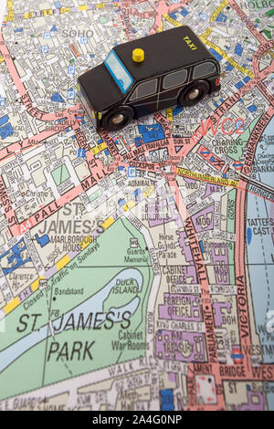 Toy taxi cab on map of west end of london, England Stock Photo