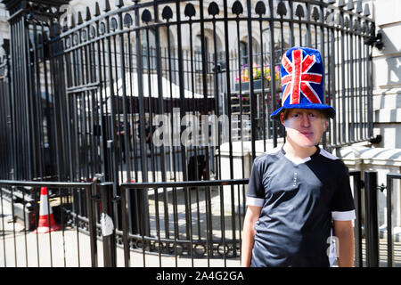 London, UK. Benjamin Wright, 13, wears a Boris Johnson mask at the gates of Downing Street. Stock Photo