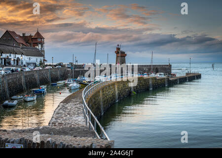 As the sun goes down the streetlights flicker on around the picturesque little North Devon harbour of Lynmouth. Stock Photo