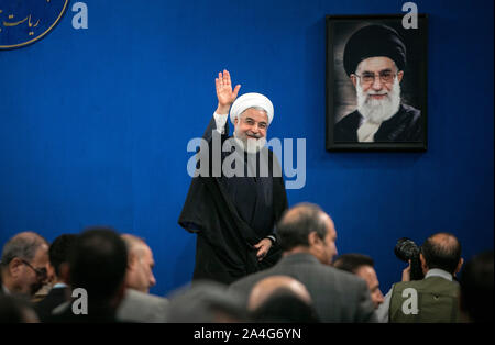 Tehran, Iran. 14th Oct, 2019. Iranian President Hassan Rouhani waves after a press conference in Tehran, Iran, on Oct. 14, 2019. Iranian President Hassan Rouhani said on Monday that his country does not endorse Turkey's approach to the current issues in northern Syria. Credit: Ahmad Halabisaz/Xinhua/Alamy Live News Stock Photo