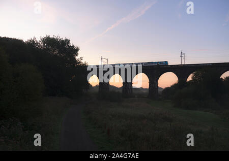 Sankey Viaduct, Earlestown, Cheshire First Transpennine Express class 185 diesel train crossing the viaduct at sunrise Stock Photo