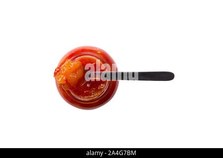 isolated on white background jar of marmalade or jam of tomato apple strawberry orange fruit cherry with a spoon photographed top down on a pure white Stock Photo
