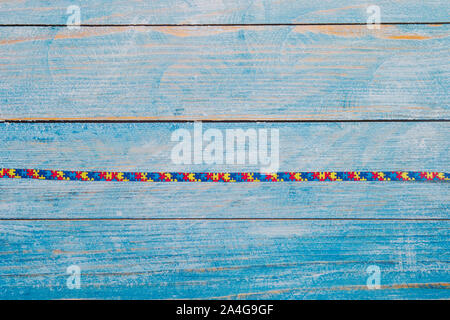 World Autism awareness and pride day or month with Puzzle pattern ribbon on wooden background. Stock Photo