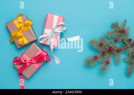 Christmas gift boxes with decoration on blue background. Stock Photo