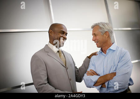Two smiling businessmen having a discussion. Stock Photo