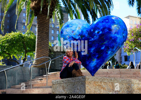 Tourist on Union Square Park in San Francisco with Hart on Display Stock Photo