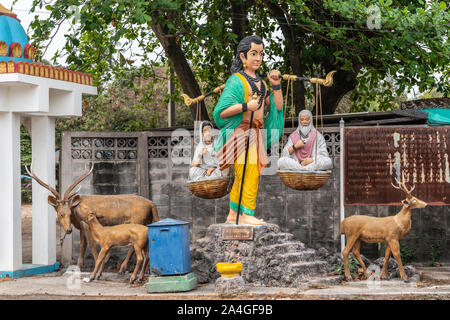 Bang Saen, Thailand - March 16, 2019: Wang Saensuk Buddhist Monastery. Colorful statue presenting gender equality in the eyes of Buddha as he carries Stock Photo