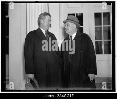 Tugwell's successor at White House with boss. Washington, D.C., Dec. 22. Secretary of Agriculture Henry a Wallace, (left) and Dr. W. Alexander, successor to Rex Tugwell as Resettlement Administrator leaving the White House following a conference with the President Roosevelt. Wallace told newpapermen the President will issue an executive order transfering the RA to the Agriculture Department as soon as Attorney General Cummings draws up the legal form Stock Photo