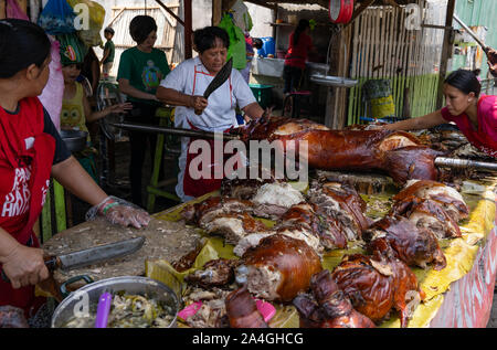 Roasted pig for sale at a street stall in talisay City,Cebu.Known as Lechon,a delicacy within the Philippines.Fiestas and birthdays are quite often ce Stock Photo