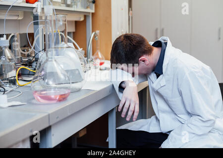 scientist sleeps in the workplace in a medical laboratory Stock Photo