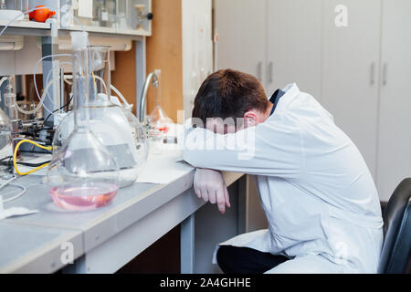 scientist sleeps in the workplace in a medical laboratory Stock Photo