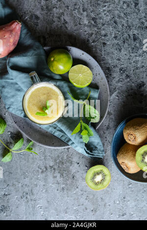 Sweet kiwi smoothie with prickly pear and lime juice in a glass jar Stock Photo