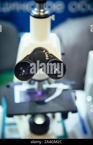 Ocular eyepiece lenses of binocular microscope, close up, selective focus. Stock Photo