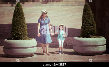 Cordoba, Spain - June 20, 2019: Mother and her daughter with hat sightseeing in a sunny day Stock Photo
