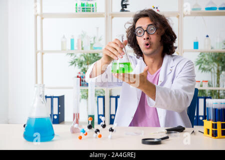 The funny male chemist working in the lab Stock Photo