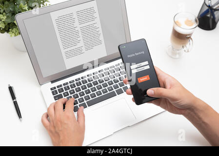 Man using mobile banking application on smartphone Stock Photo