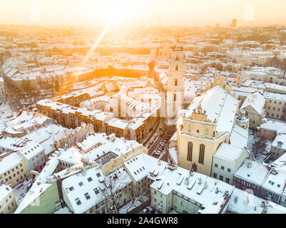 Beautiful Vilnius city panorama in winter with snow covered houses, chruches and streets. Aerial evening view. Winter city scenery in Vilnius, Lithuan Stock Photo